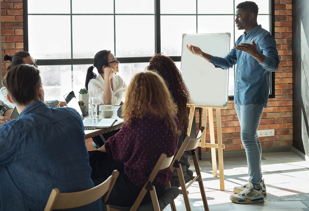 African-american leader lecturing his employees in office
